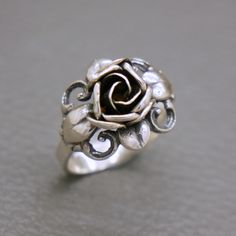 An elegant vintage sterling silver flower design ring. The famous Biedermeier rose flower design by TEKA  (TEKA studio in Pforzheim, Germany, was founded by Theodor Klotz in late 1940's). A high quality hand crafted mid century German design jewelry from circa 1950's. The ring will be shipped in a gift box.   Ring size: 16.3 mm in diameter / US size: 5 3/4  /  UK size: L 1/4 / EU size : 52 Ring face measures 3/5 inches tall (1.5 cm) Weight: 4.1 grams The ring was hallmarked for 925 sterling silv Elegant Sterling Silver Rings With Roses, Vintage Flower Shaped Ring As Gift, Vintage Rose Design Jewelry In Rose Color, Vintage Rose Design Jewelry, Vintage Flower-shaped Ring As A Gift, Vintage Style Flower Shaped Rings For Gift, Vintage Flower Shape Rings For Gift, Vintage Rose Jewelry For Anniversary, Vintage Rose-colored Jewelry For Anniversary