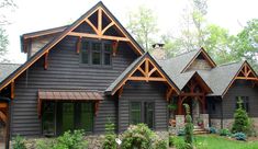 a large house with lots of windows and wood trimmings on the side of it