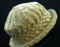 a close up of a knitted hat on a black background