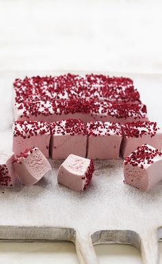 several pieces of cake with red sprinkles on top