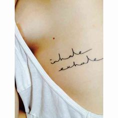 the back of a woman's stomach with arabic writing on her left side ribcage