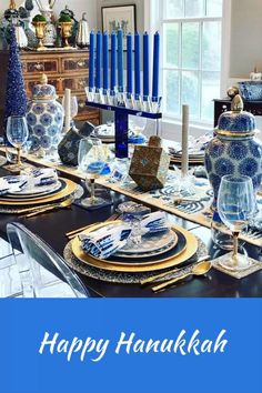 a blue and white table setting with candles on it for hanukkah celebration