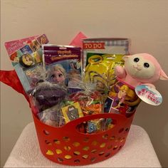 a red basket filled with toys and other items