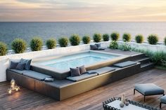 an outdoor hot tub on the roof of a house with ocean view in the background