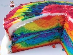 a rainbow cake with one slice cut out