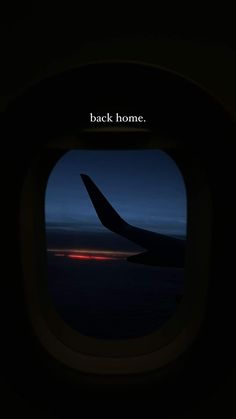 an airplane window with the words back home on it