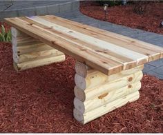 a wooden bench sitting on top of red mulch