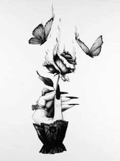 a black and white drawing of butterflies flying over a woman's head with flowers in her hair