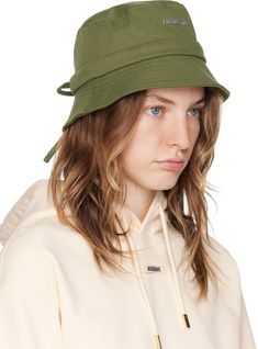 Cotton twill bucket hat in khaki. · Logo hardware at face · Quilted brim · Drawstring at back face · Poplin lining · Silver-tone hardware Part of the Les Classiques collection. Supplier color: Khaki Military Style Khaki Bucket Hat, Adjustable Khaki Military Bucket Hat, Green Military Style Summer Hat, Military Style Green Summer Hat, Military Style Green Hat For Summer, Adjustable Military Style Khaki Bucket Hat, Adjustable Military Bucket Hat, Military Style Khaki Bucket Hat With Brim, Military Style Khaki Brimmed Bucket Hat