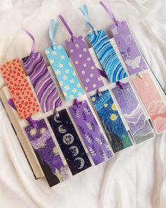 the bookmarks are lined up in different colors and patterns, along with ribbons on them