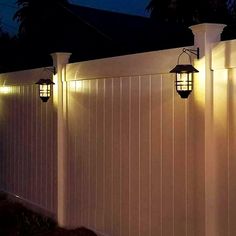 a white fence with some lights on it