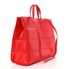 This is an authentic TELFAR Nylon Large Puff Shopping Bag in Red. This is a tote crafted of nylon in black with the iconic Telfar logo stitched on the front. The shoulder bag has short top handles, and two long shoulder straps. The top secures with a magnet snap and opens to a red fabric lined interior with zipper and patch pockets. 1382820 Solid Color Nylon Shopping Bags, Large Capacity Red Nylon Shoulder Bag, Red Nylon Shoulder Bag, Red Nylon Shopping Bag, Red Nylon Shoulder Bag With Zipper Closure, Red Quilted Travel Bag, Red Quilted Travel Shoulder Bag, Red Quilted Shoulder Bag For Travel, Red Nylon Bag With Removable Pouch