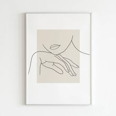 a line drawing of a woman's hand on a white wall above a framed art print