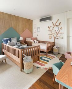 a baby's room with two wooden cribs and toys on the floor