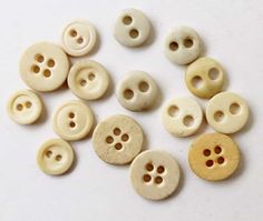 several white and yellow buttons sitting next to each other