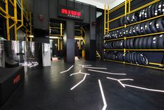 there are many tires on the shelves in this store that is painted black and yellow