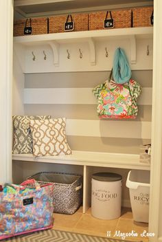 an organized mud room with baskets and bags