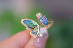 "Introducing our stunning Aquamarine Butterfly Ring - the perfect anniversary gift for that special someone or a lovely treat for yourself. 🦋💍 100% High-quality Natural Aquamarine Gemstones  💎100% High-quality Natural Diamonds 💎  ----------------------♡-------------------- Ring Setting: ●Main stone: 1.0 ct Natural Aquamarine Gemstone ●Material: 18k Gold ●Free Jewelry Certification: A globally recognized certification will come with this fine gem jewelry ●Packaging: All items are nicely packaged ready to gift in elegant jewelry boxes ----------------------♡-------------------- Important Note: ●Since every piece of jewelry is unique and made-to-order for you, the sizes of stones and metal weights may vary slightly. ----------------------♡-------------------- Processing & Free Shipping: ● Luxury Enamel Gemstone Ring For Gift, Blue Enamel Ring With Polished Finish As Gift, Blue Enamel Ring With Polished Finish For Gift, Elegant Blue Enamel Sterling Silver Ring, Elegant Blue Enamel Ring In Sterling Silver, Luxury Enamel Rings Perfect As Gifts, Luxury Enamel Ring As Gift, Luxury Enamel Rings As Gift, Luxury Gemstone Butterfly Ring As Gift