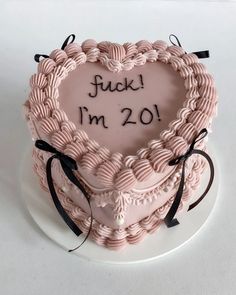 a heart - shaped cake with the words i'm 20 written on it in black lettering