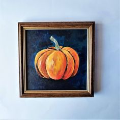 a painting of a pumpkin hangs on the wall