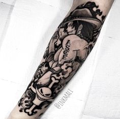 a man's arm with a cartoon character tattoo on it