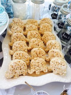 cookies are arranged on a platter in front of jars