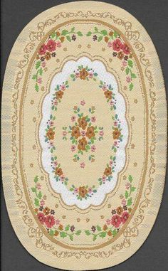 an oval rug with flowers and leaves on the center is shown in yellow, green, red