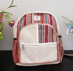 "Namaste Fashionable Unisex Multicolor Natural Hemp Handmade Organic Vegan Eco-Friendly Backpack. Hemp fabric is made by hand on a loom, it is completely handmade backpack and is made in Nepal with love and care. The bag features 1 large main zipped compartment, 2 front zipped compartment and 2 side pockets. No child labor is used and is fairly traded. No harmful chemicals has been used. Each print in the backpack represents rich art in Nepal, the print looks unique and special and the color rep Handmade Multicolor Backpack For School, Handmade Multicolor School Backpack, Casual Woven Standard Backpack, Handmade Multicolor Standard Backpack, Casual Handmade Rectangular Backpack, Casual Everyday Woven Backpack, Eco-friendly Multicolor School Backpack, Multicolor Cotton Backpack For Daily Use, Handmade Multicolor Casual Backpack