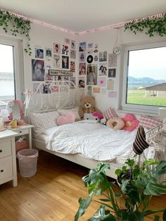 a bed room with a neatly made bed and lots of pictures on the wall