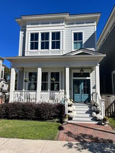 a house with white trim and blue doors