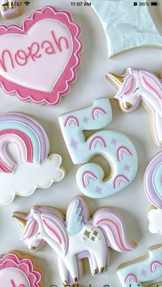 decorated cookies are arranged in the shape of unicorns