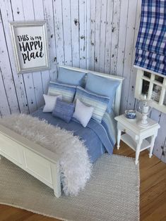 a white bed sitting next to a wooden wall