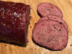 three slices of meatloaf sitting on top of a cutting board next to each other