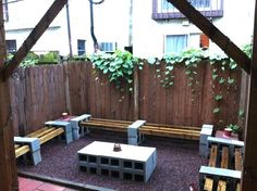 an outdoor seating area with benches and tables