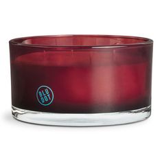 an image of a red candle that is in the shape of a glass bowl on a white background