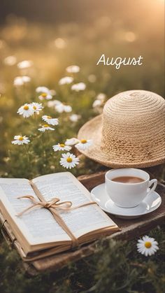 an open book and cup of coffee on a wooden tray with daisies in the background