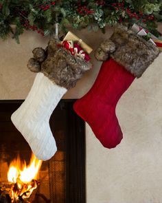 two christmas stockings hanging from a fireplace