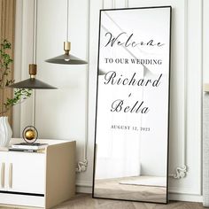 a large mirror in the corner of a room with a welcome sign on it's side