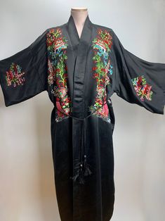 Vintage Chinese Silk Kimono in black with colorful embroidery details on the front, back as well as the sleeves. The inside is totally lined with a sheer black silk. This comes with a woven black sash with fringe. This piece is quite striking. This would make a great dressing gown, lingerie or cape-like jacket for a special night out.. This also could be hung on a wall with a bamboo rod as a beautiful art piece. This is in EXCELLENT VINTAGE CONDITION.. with one flaw to mention.. There is a snag Arrow Fabric, Chinese Silk, Colorful Embroidery, Pajama Robe, Vintage Kimono, Silk Kimono, Dressing Gown, Embroidery Details, Black Silk