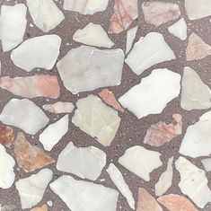 a close up view of some white and brown pieces of glass on the ground,