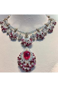 an elaborate necklace with red and white stones