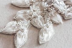 Nostalgic of precious jewelry, each MillieIcaro Sash is made from pearls, mounted swarovski crystals, and silk thread. Beautifully intricate, each sash emanates old Hollywood Glamor and vintage feel making it both luscious and trendy. A prefect bridal belt to add on a simple wedding dress to add shimmer. * Offwhite fabric work with silver beading and swarovski rhinestones* The beaded section is about 14.5 inch in length with a max width in the center about 4 inches. This tapers on either side to Wedding Belts And Sashes, Flowers And Crystals, Hollywood Glamor, Wedding Sash Belt, 3 Shoes, Bridal Sash, Wedding Belts, Dress Belt, Bridal Belt