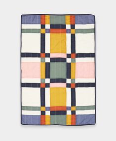 a multicolored quilt on a white background with an orange, yellow and blue checkered design