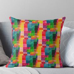 a colorful pillow sitting on top of a couch