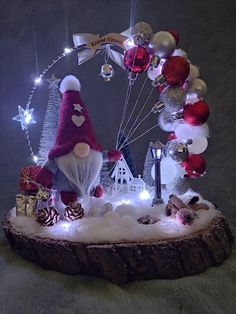 a christmas scene with santa claus and other decorations on a tree stump in front of a ferris wheel