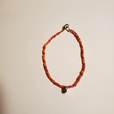 Having a Warm feel to this dainty Love Bracelet. I used 2 Glass Seed beads colors to make this. I put a lobster clasp and a ring hoop at the end of the bracelet to secure it. The string that I use is elastic and it has a little bit of a stretch.  I added a few scoops of each color to my wooden bead spinner. So each bracelet and necklace I make is unique in design. Everyday Colorful Beads Orange Jewelry, Orange Beaded Bracelets With Heart Beads As Gift, Orange Beaded Bracelet With Heart Beads As Gift, Orange Heart Beads Beaded Bracelet For Gift, Orange Heart Beads Beaded Bracelet As Gift, Adjustable Beaded Bracelets With Lobster Clasp For Everyday, Orange Letter Beads Bracelet Jewelry, Orange Heart Beads Jewelry For Gift, Orange Heart Beads For Jewelry Making