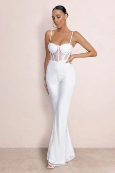 Carefully designed for special events, our must-have ‘’First Look’’ jumpsuit will keep you looking effortlessly gorgeous at any event this season. With glamorous neckline, delicate cami straps and on-trend corset bodice design for a curve contouring look. Its flared trousers will create the illusion of timeless legs and the chic lace material oozes elegance and sophistication. This style is perfect for the reception look, its stretchy fabric will keep you comfortable from dusk till dawn. Modern elegance at its finest.  Features  - Cami straps  - Moulded cups  - Corset bodice  - Flared trousers  - Lace fabric    Sizing & Fit Model is 5’8 and wears UK size 8 / US size 4   Product Information   Fully lined and with a good amount of stretch Lace and slinky fabric (100% Polyester) Inside le