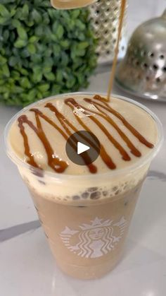 starbucks iced coffee with caramel drizzle and whipped cream on the top, sitting on a table