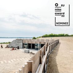 an image of a building on the beach with people walking around it and in the background there is a sign that says eu miles award 22 nomiee