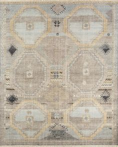 an area rug with many different shapes and colors on it, including grays, yellows